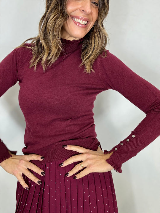 Il pull dolcevita con i fru fru e i bottoncini