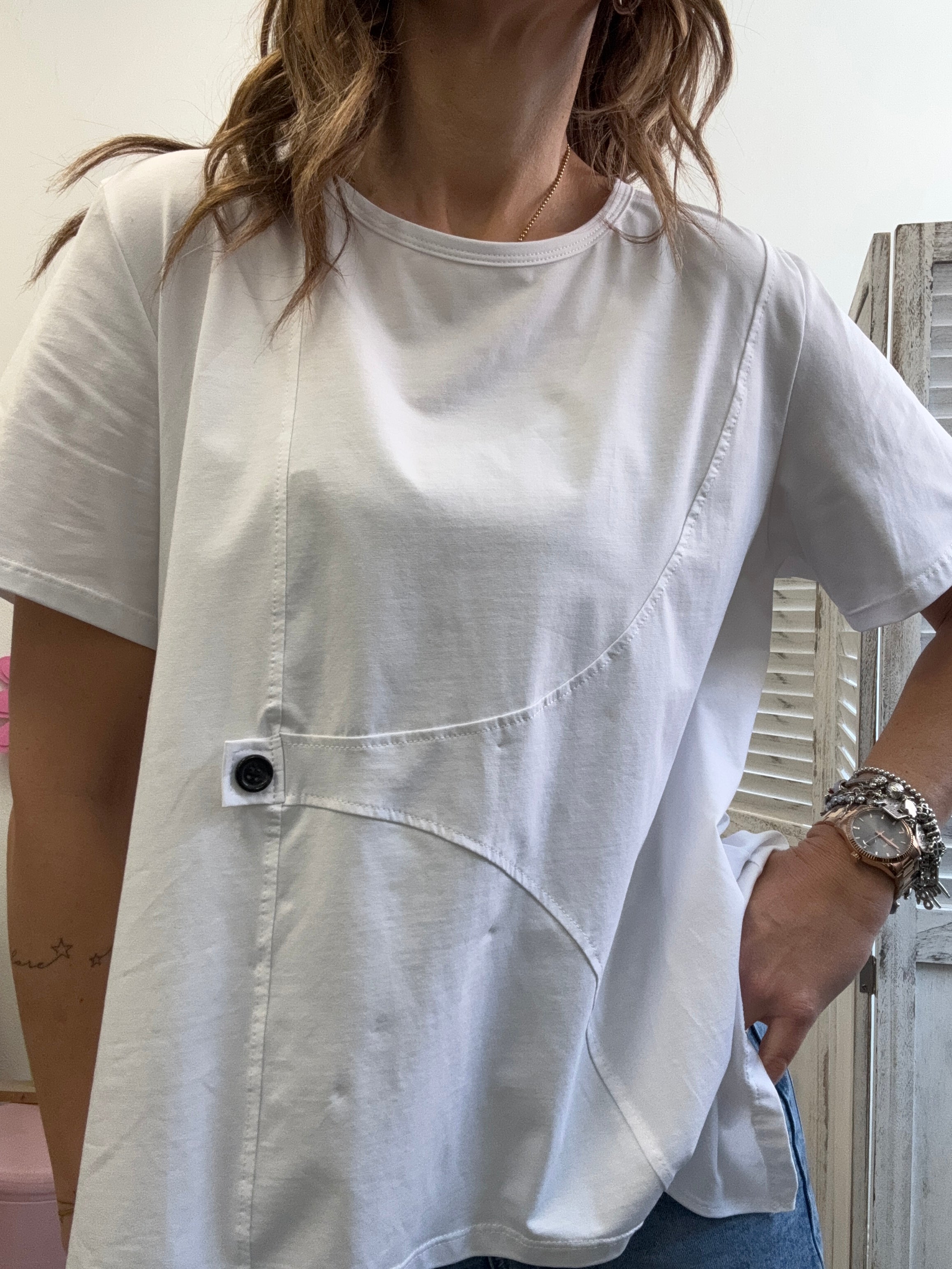La t-shirt irregolare col bottone